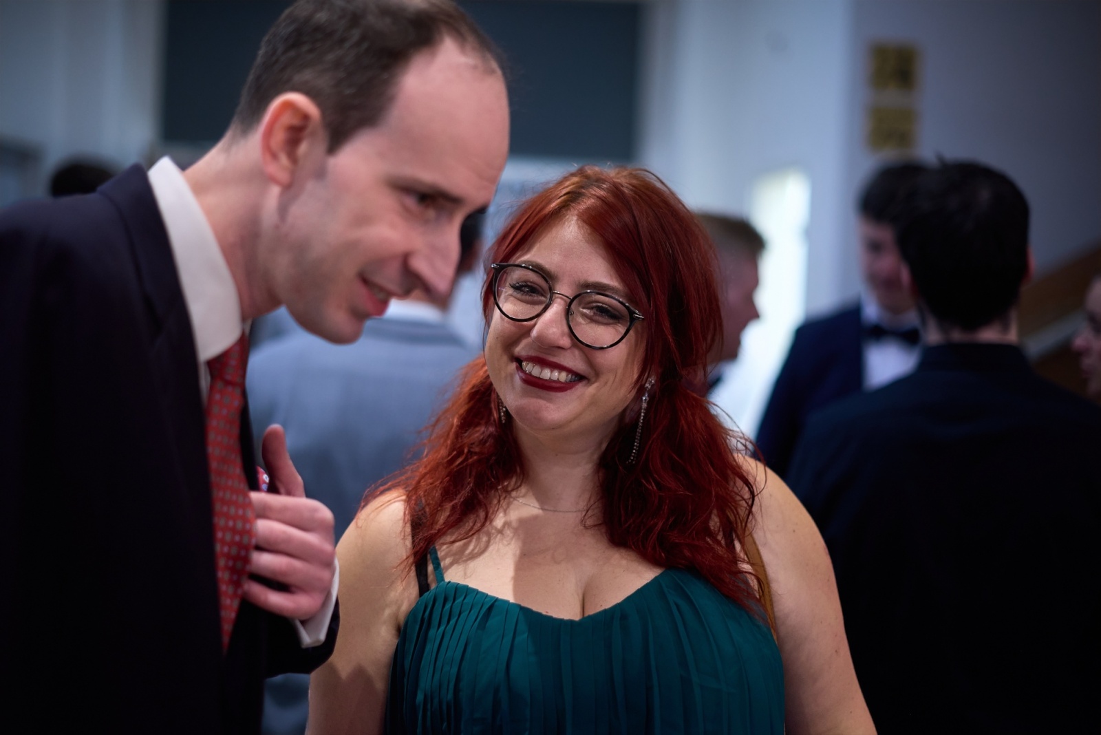 Two guests smiling towards the camera at a gala