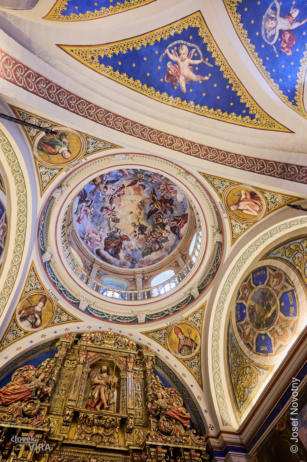 Painted dome and gilded arches seen from below