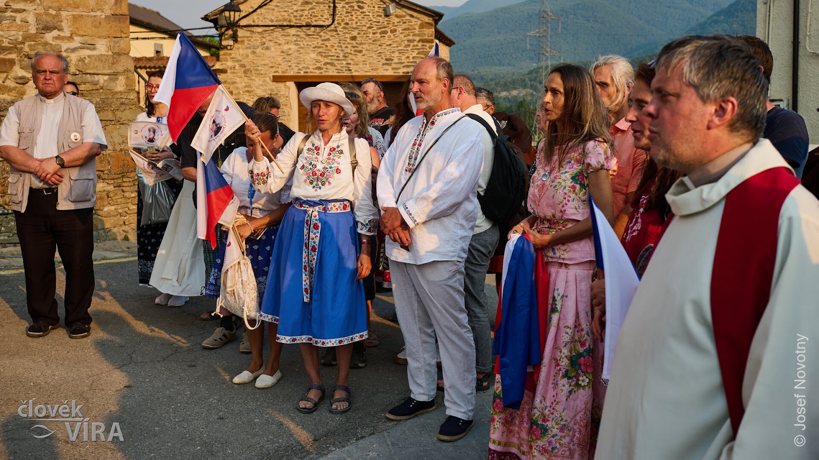 Pilgrims in Moravian folk costume with a Czech flag