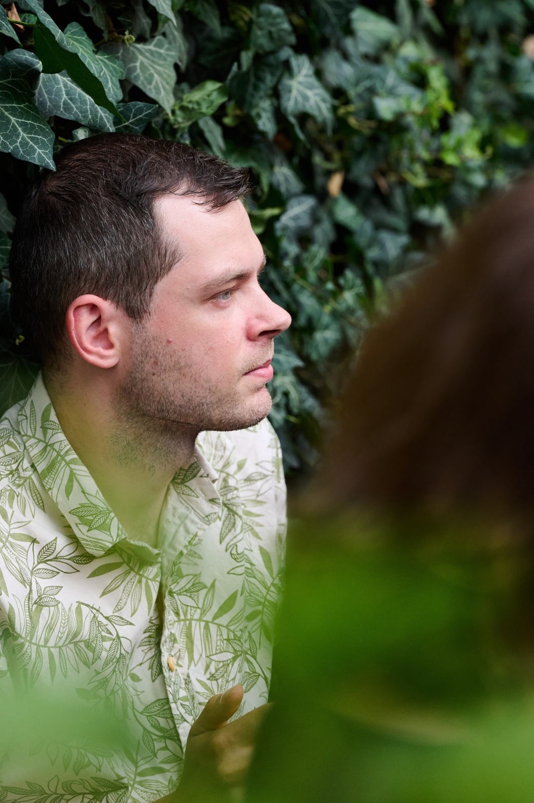 Profile portrait of a man in soft green light