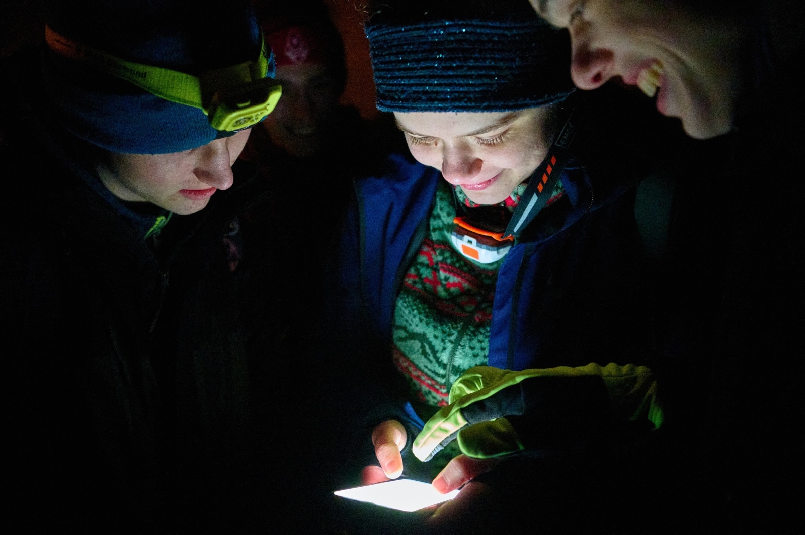 Player reading a clue by headlamp light in the dark